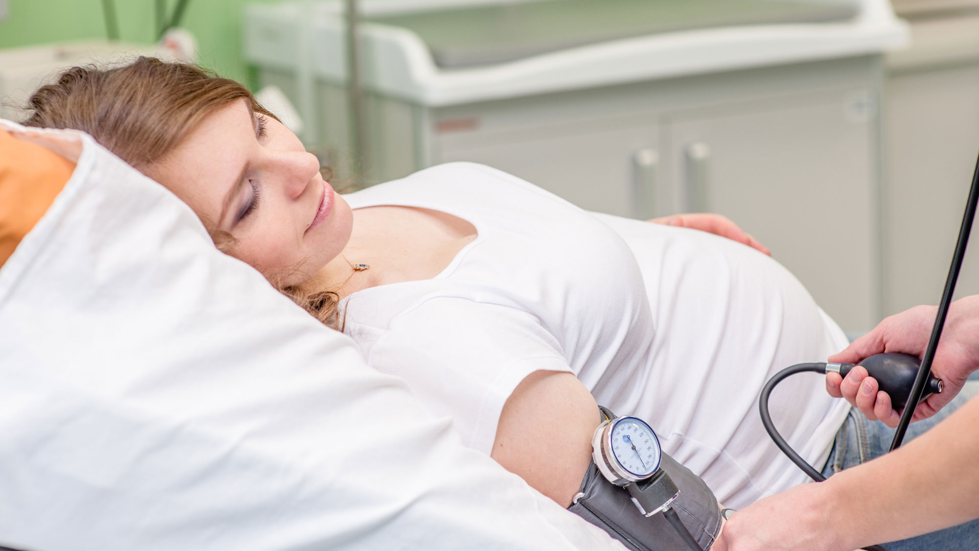 Pregnant woman having her blood pressure measured