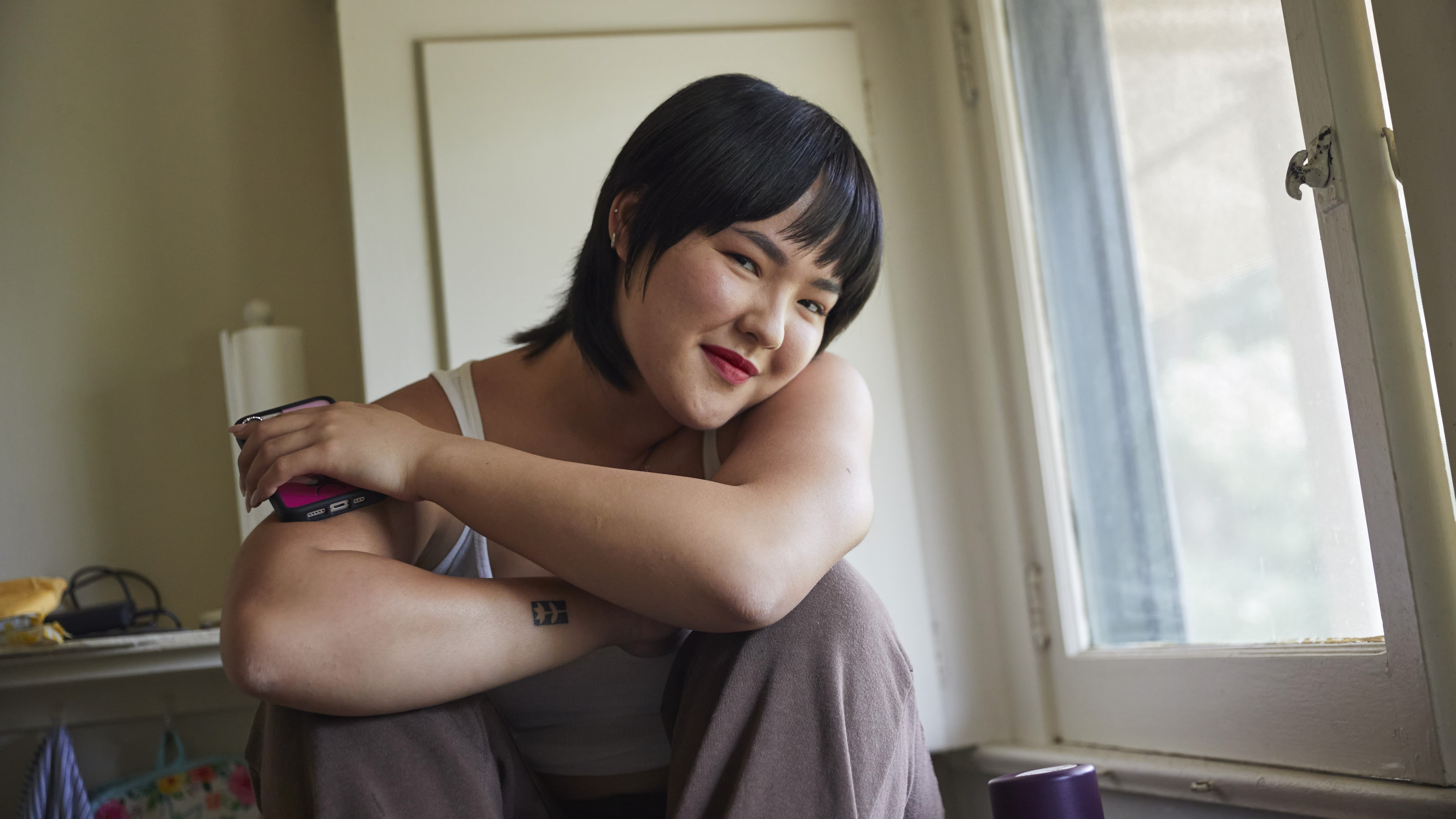 Woman sitting by window smiling