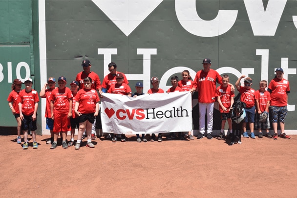 Clinic participants pose for photos in front of the Green Monster.