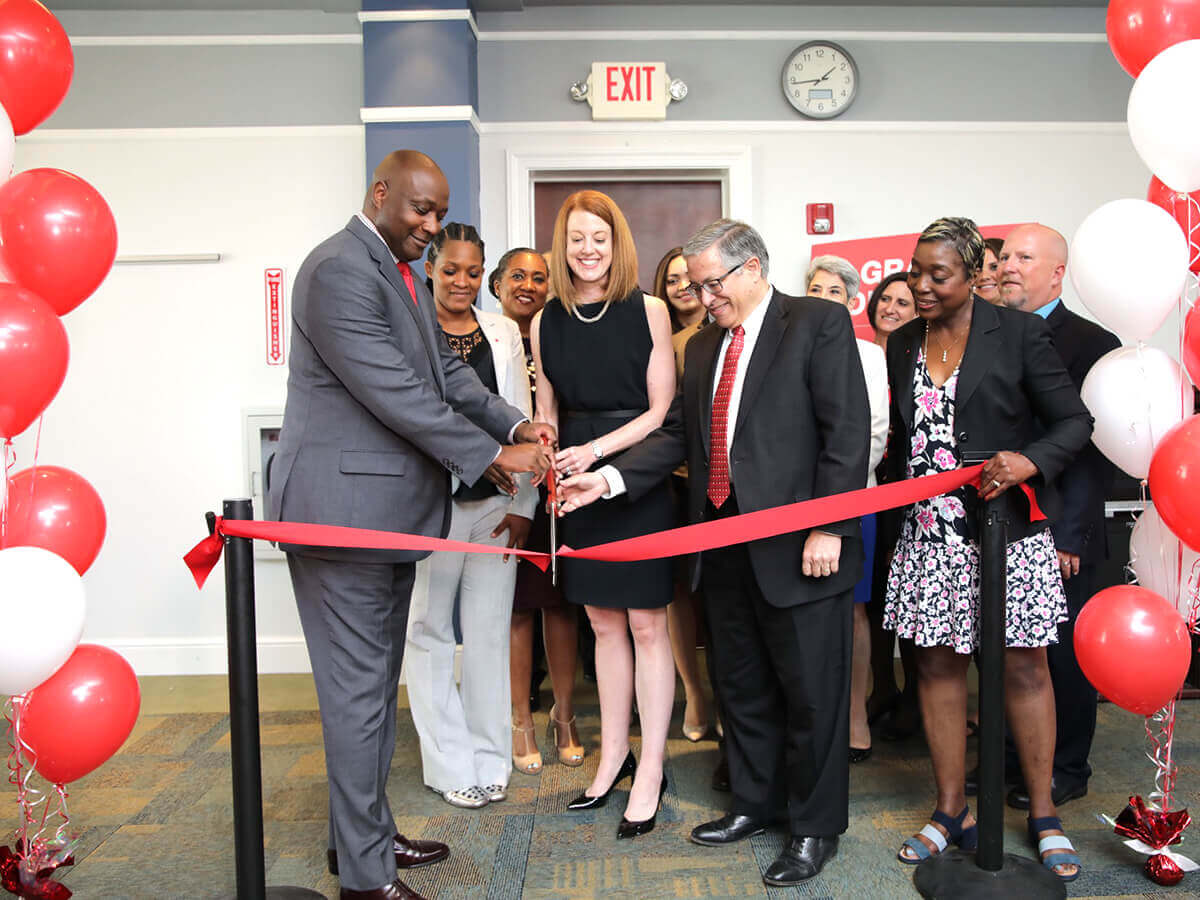 A group of people cut the ribbon at the Workforce Innovation and Talent Center in Cleveland.