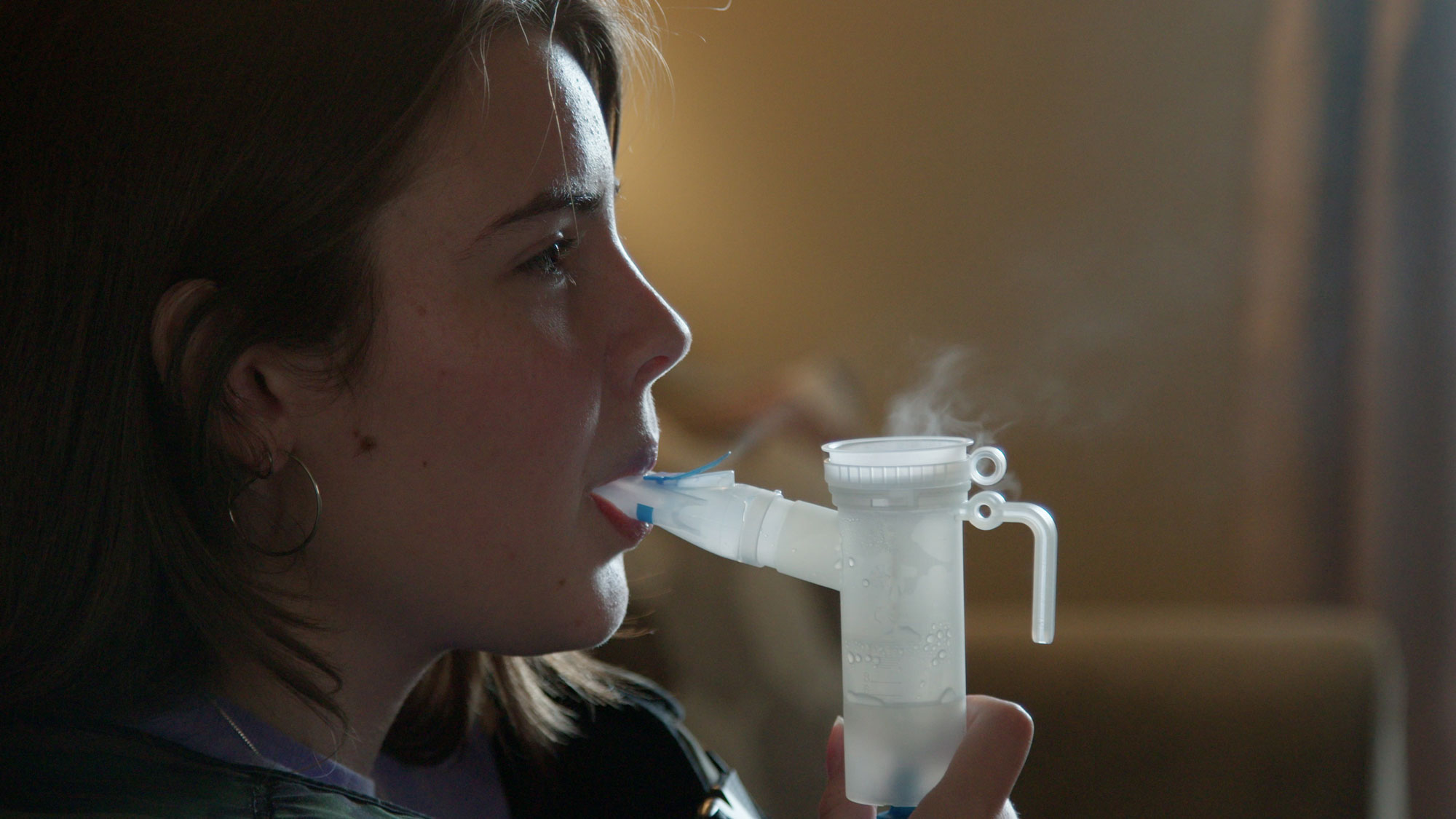 A woman using a nebulizer for her chronic illness