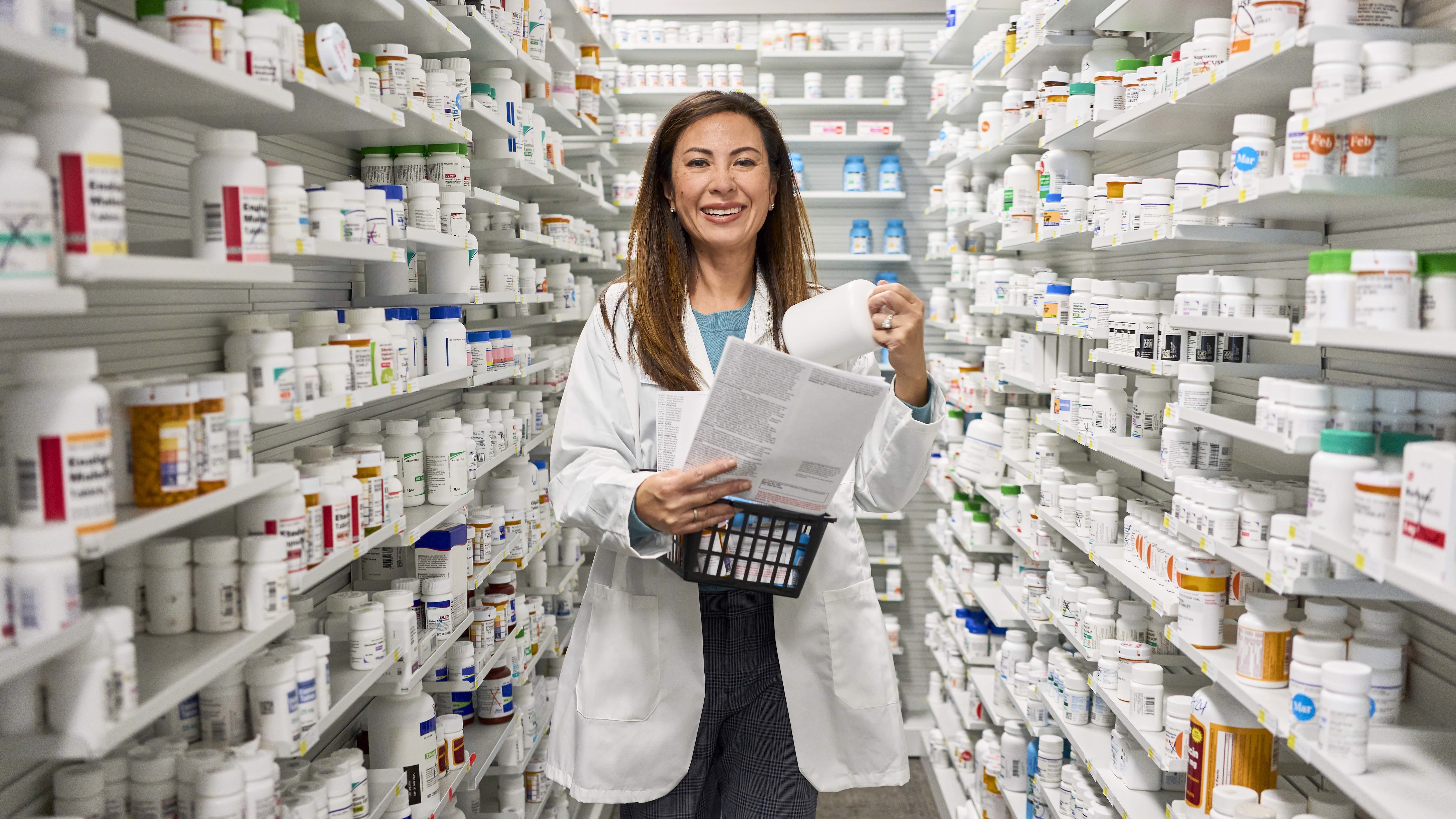 Female pharmacist organizing prescriptions in the pharmacy